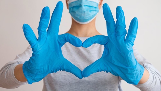 nurse-making-heart-with-hands-and